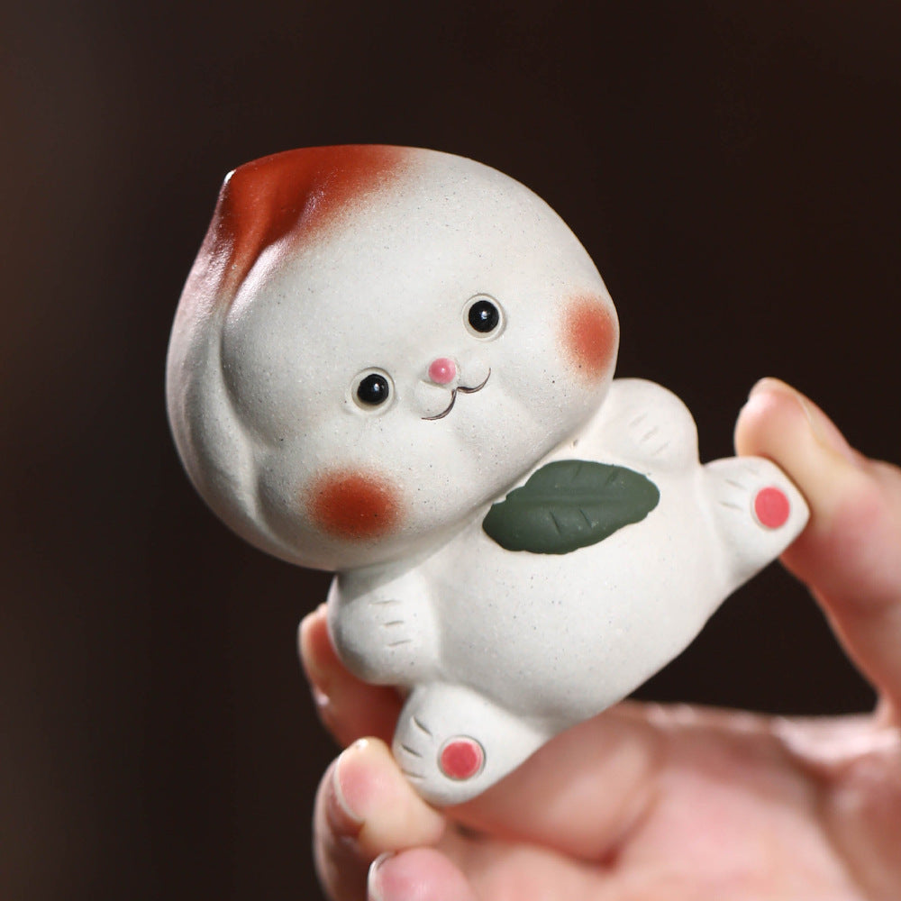 Mascottes de thé plum en argile