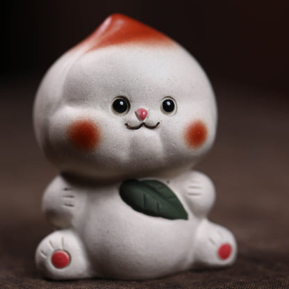Mascottes de thé plum en argile