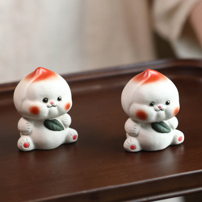 Mascottes de thé plum en argile