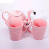 Théière en porcelaine rose avec deux tasse