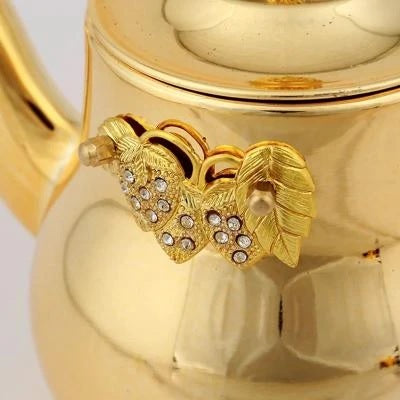 le décor d'une théière inox dorée